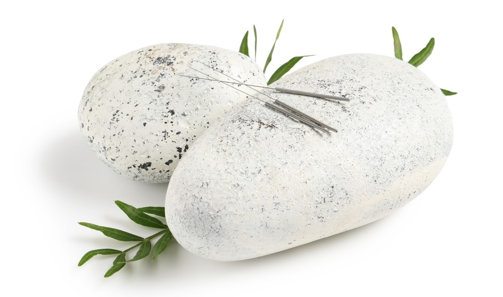 Zen stones with acupuncture needles and rosemary